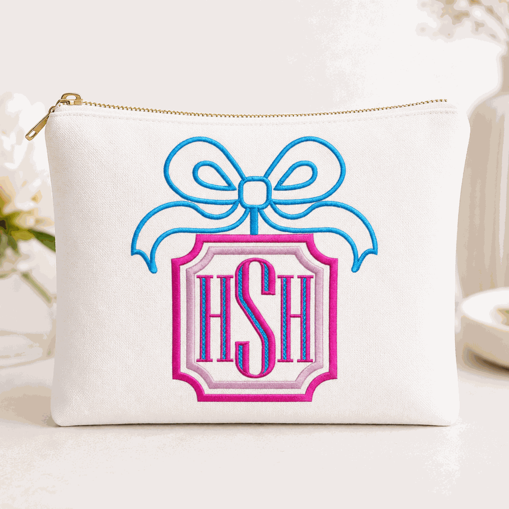 Pink and blue HSH monogram embroidery with bow displayed on a white cosmetic pouch mockup