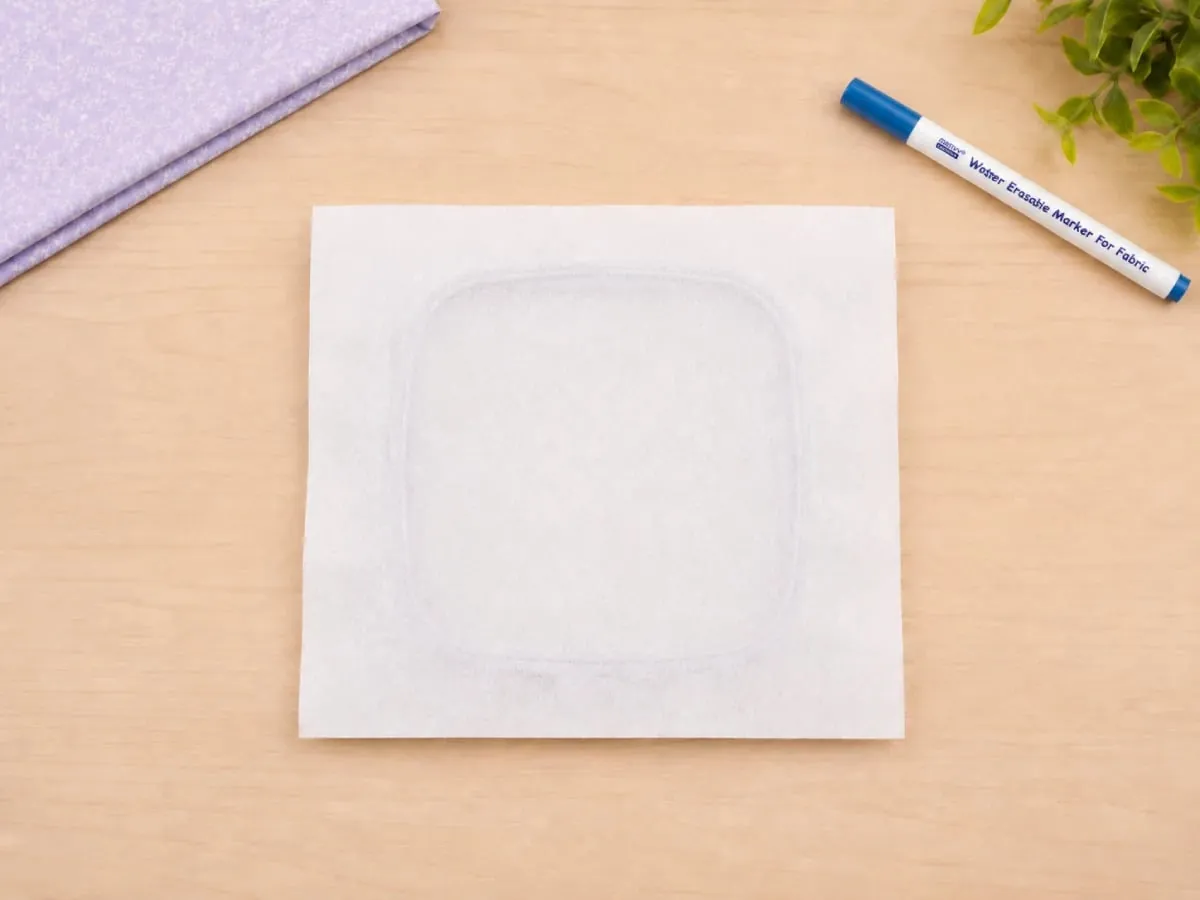Cut stabilizer larger than the hoop so it can be gripped securely during stitching.