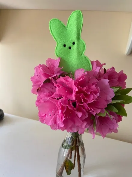 Green bunny silhouette feltie on a stake in a vase of pink azalea flowers