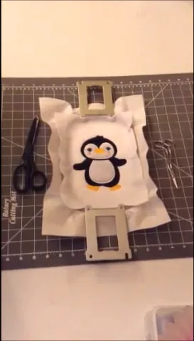 Finished penguin patch still in the hoop after the satin border has stitched