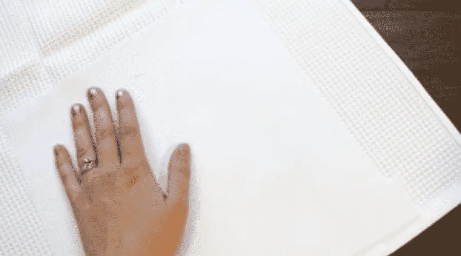 Iron the embroidered area flat before you start embroidering.