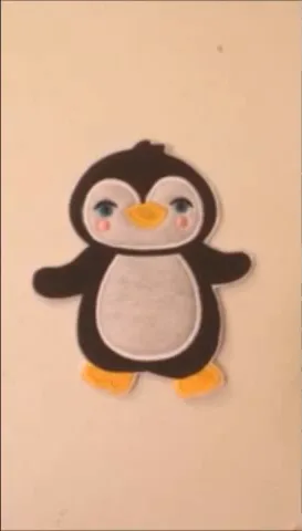 Finished penguin applique embroidered patch cut out and ready for backing
