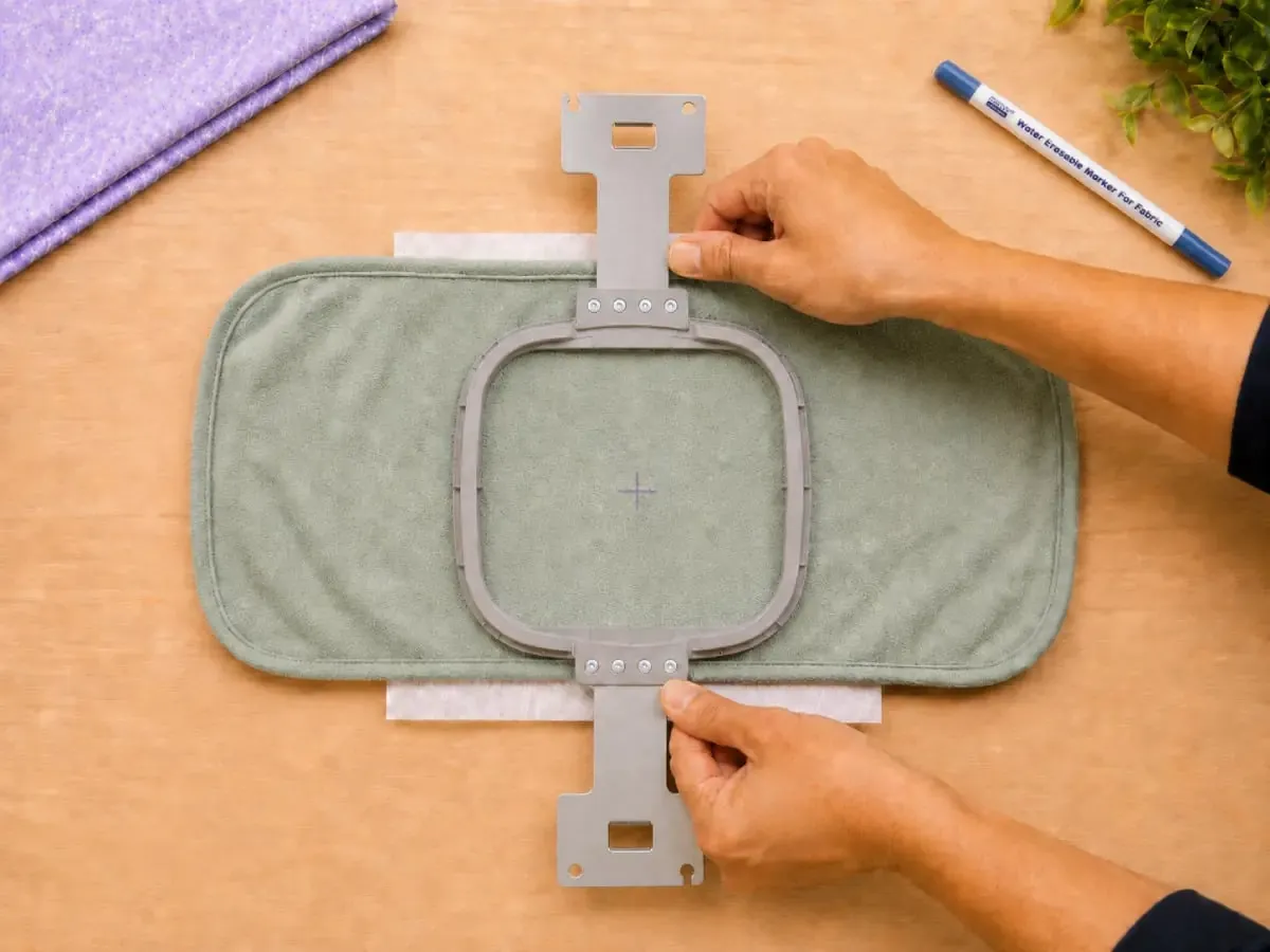 Press the top hoop down evenly to keep fabric tension balanced.