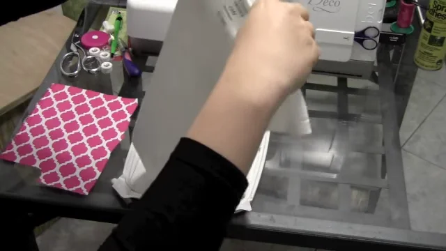 Sliding the onesie over the embroidery hoop from the bottom opening