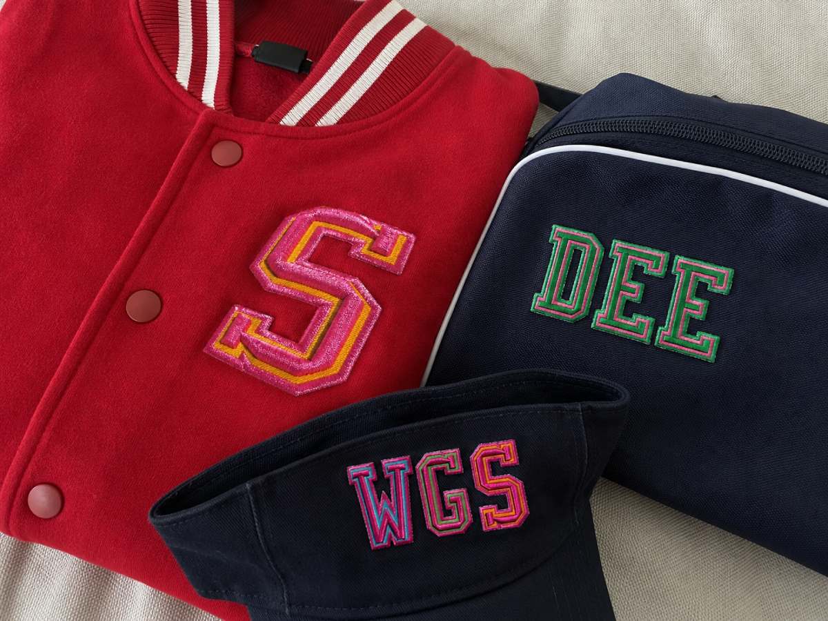It has the energy of letterman jackets, sports bags, caps, and bold campus-style personalization.