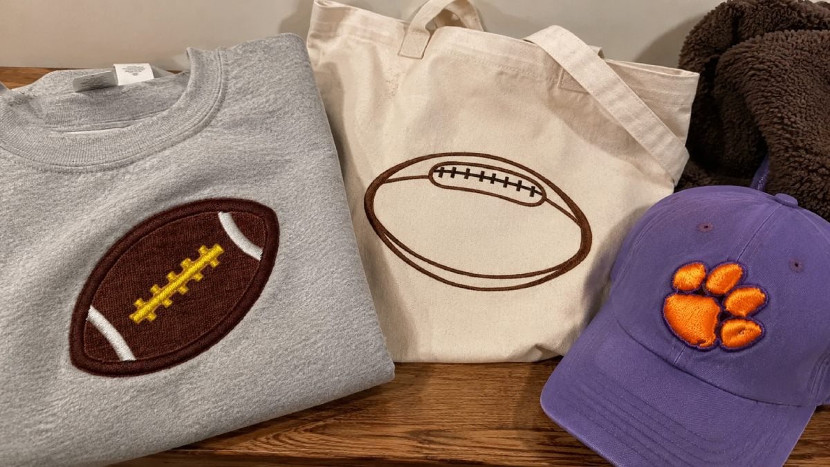 Baseball, basketball and soccer designs may include balls, equipment, player figures, decorative frames, stitching details and short athletic sayings.
