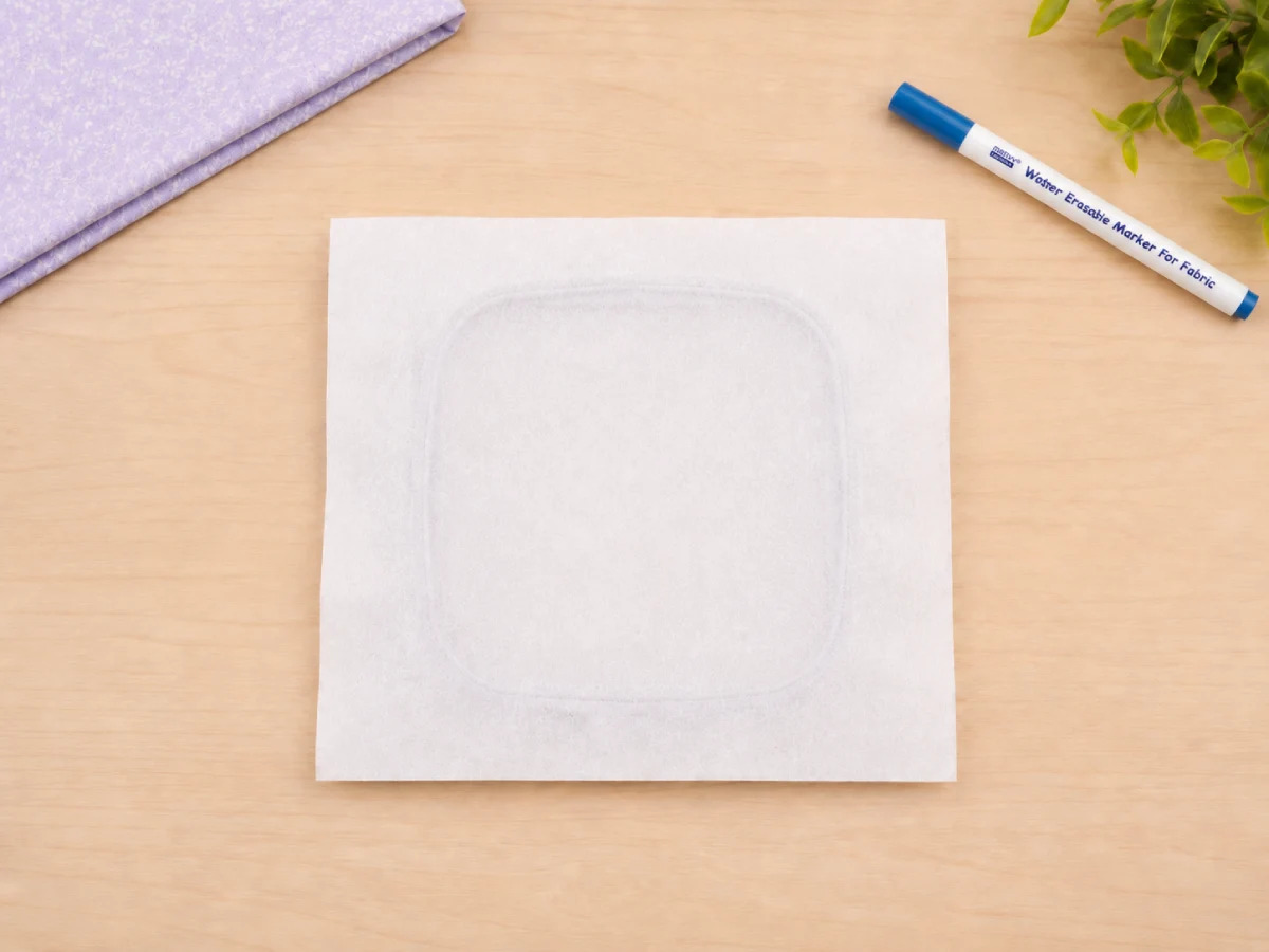 Cut stabilizer larger than the hoop so it can be gripped securely during stitching.