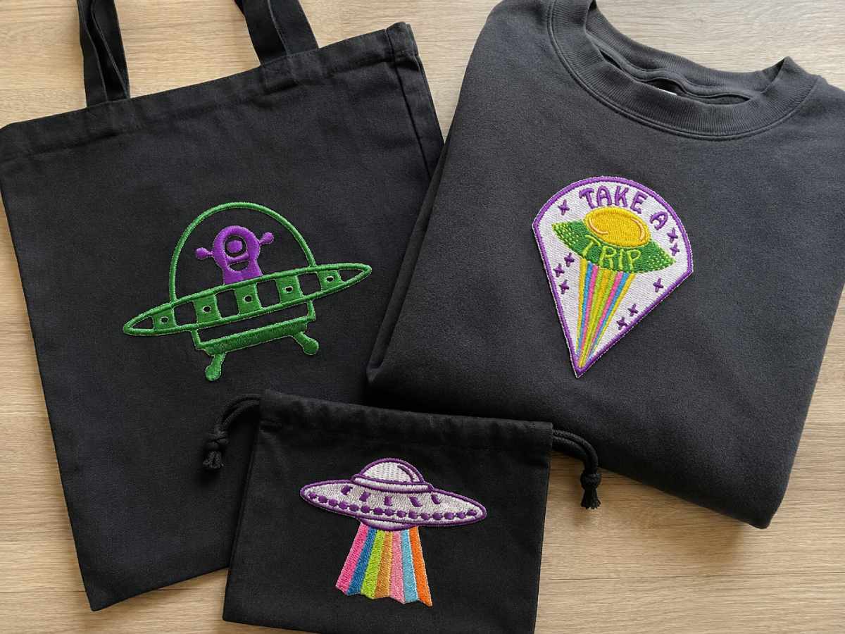 An alien is a character. A flying saucer suggests that something is happening.