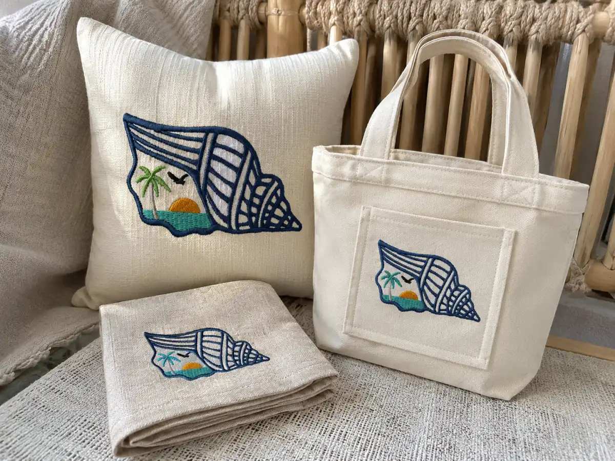 Seashell and sunset embroidery designs make everyday pieces look calm, polished, and beach-inspired.