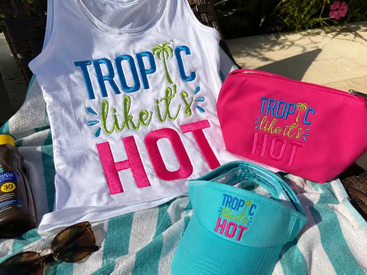 Tropic Like It’s Hot embroidery adds a bold, playful summer vibe to tanks, pouches, visors, and other bright vacation-ready accessories.