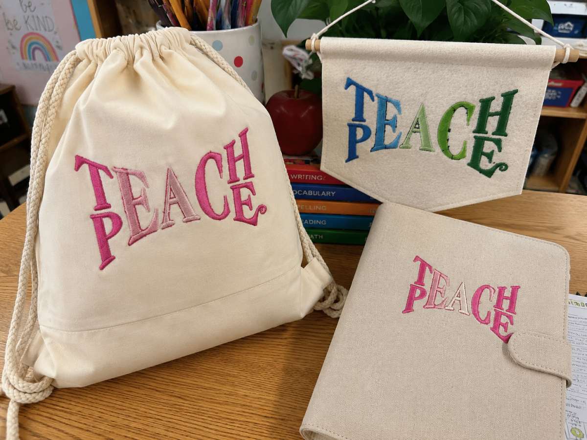 Motivational teacher embroidery brings a bright back-to-school feel to aprons, totes, and shirts.