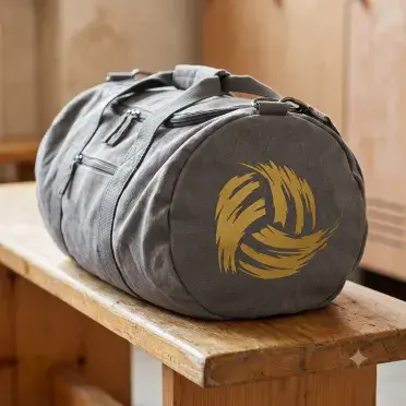 Distressed volleyball SVG cut in gold on the end panel of a grey canvas duffel bag on a wooden locker bench