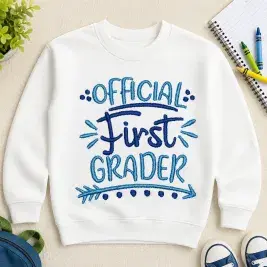 Blue Official First Grader embroidery design stitched on a white kids sweatshirt for first day of school and back-to-school outfits