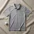 Best Dad by Par SVG cut in green on a heather grey golf polo laid flat, with a golf ball and wooden tee beside it